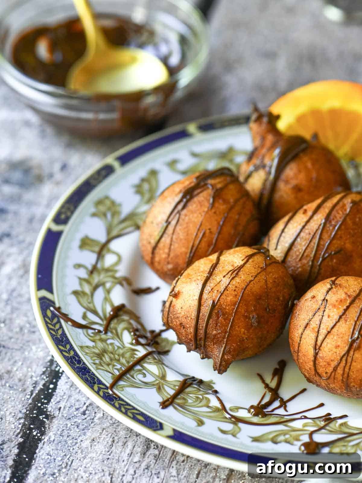 Orange Ricotta Zeppole: Classic Italian Ricotta Doughnut Recipe 7 Ricotta donuts with chocolate drizzle on a blue plate.