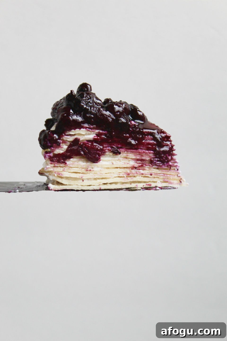 Gluten Free Crepe Cake Recipe & Blueberry Topping Slice on Knife