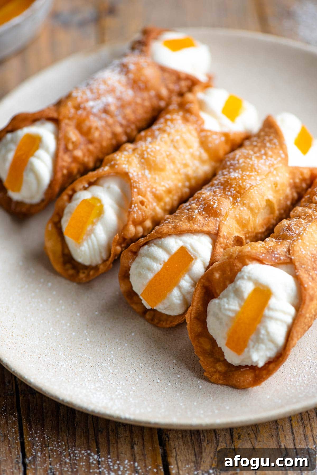 Homemade Sicilian Cannoli Recipe: Crispy Shells & Ricotta Filling 9 A close up of four cannoli filled with ricotta