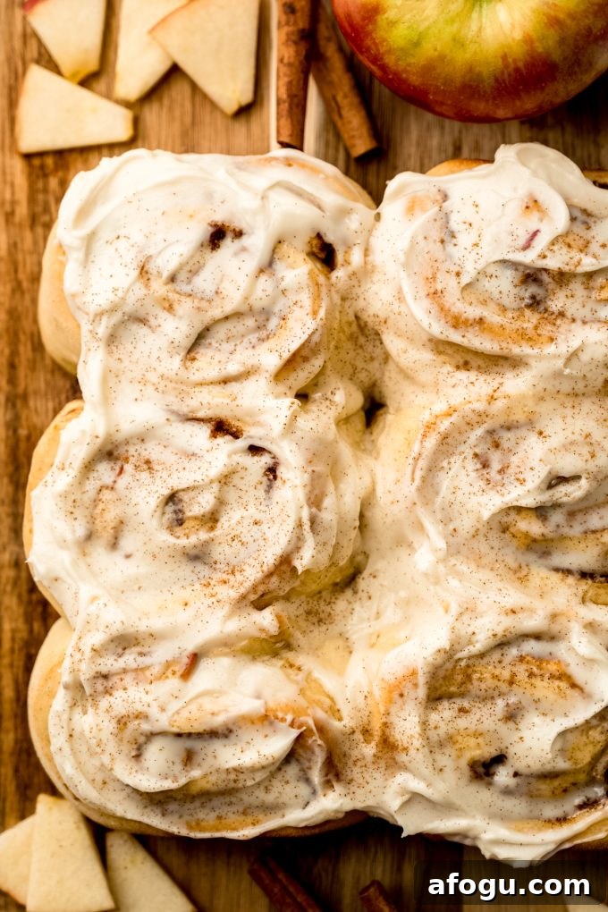 Aerial photo of apple cinnamon rolls on a cutting board.