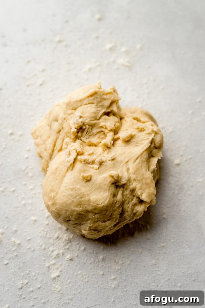 A ball of yeasted cinnamon roll rough before it's been kneaded.