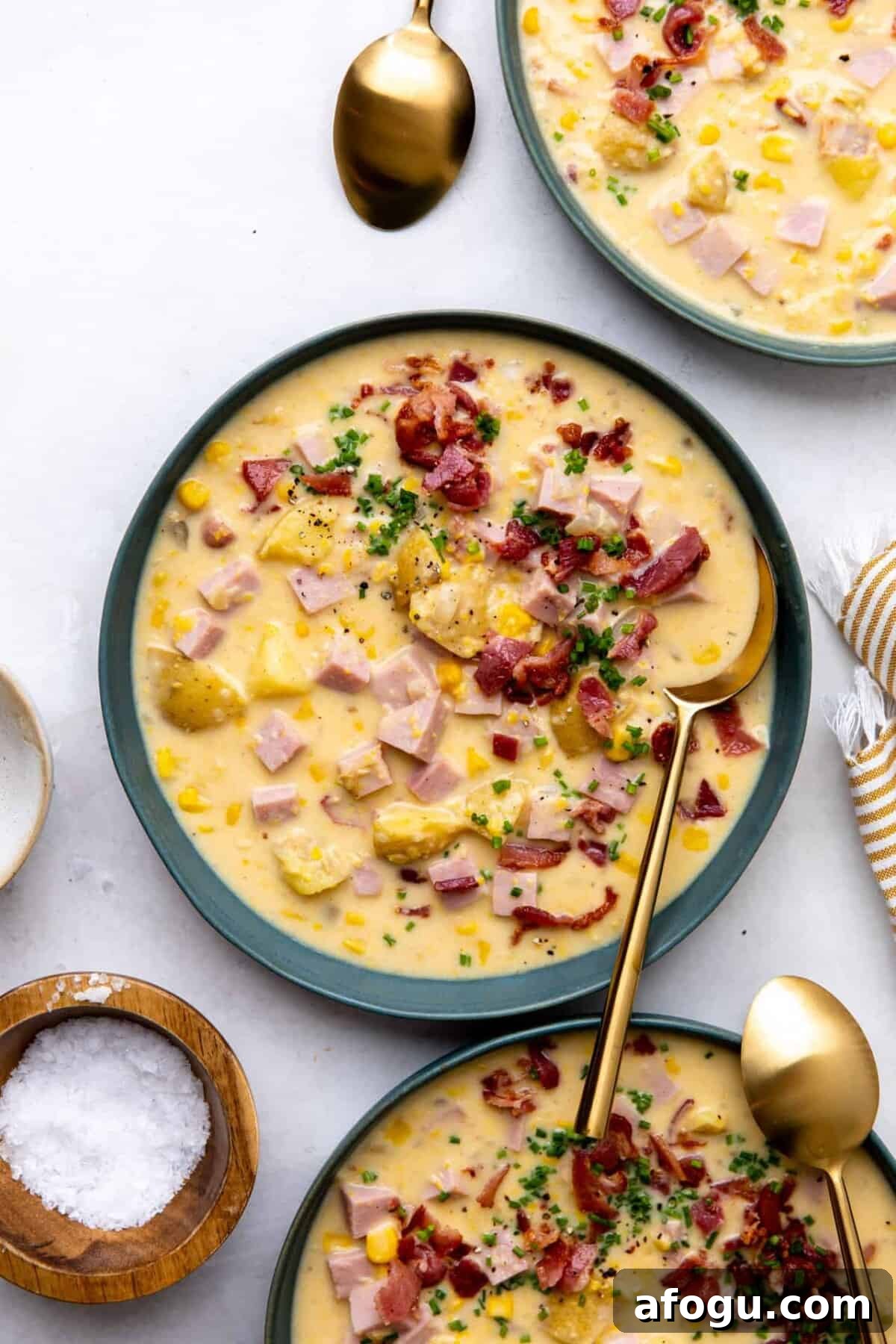 Corn chowder in a bowl with a spoon. 