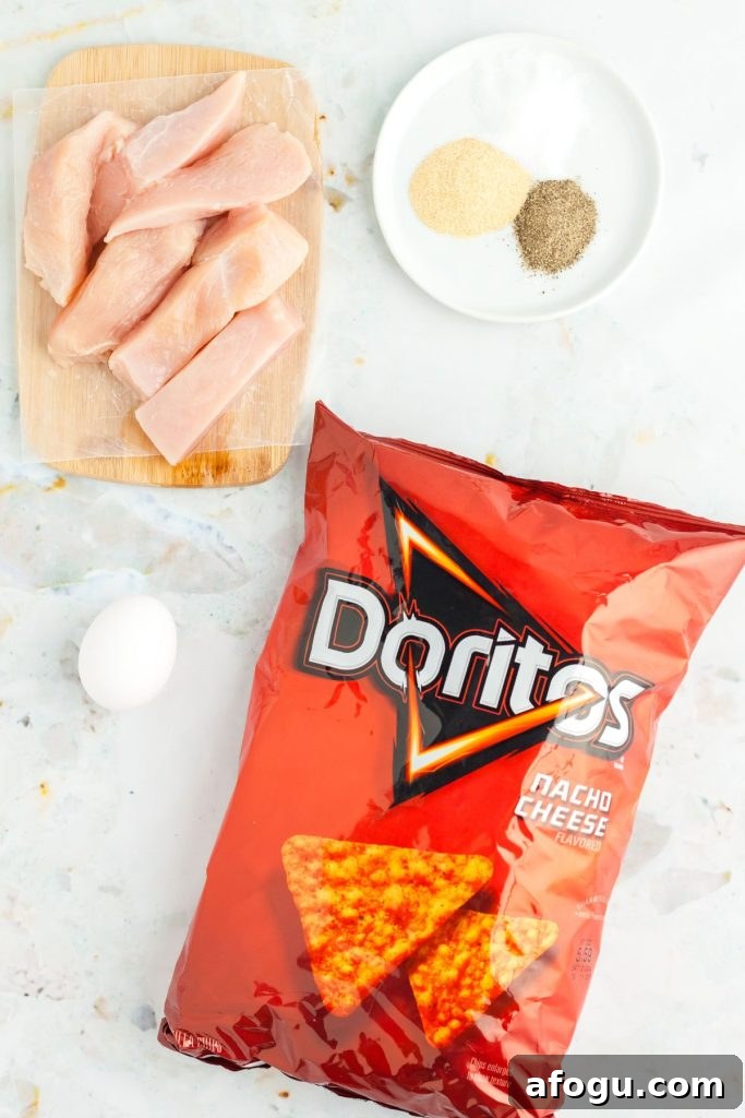 Crispy Dorito-Crusted Air Fryer Chicken Recipe 3 Ingredients needed to make Dorito chicken on a marble board