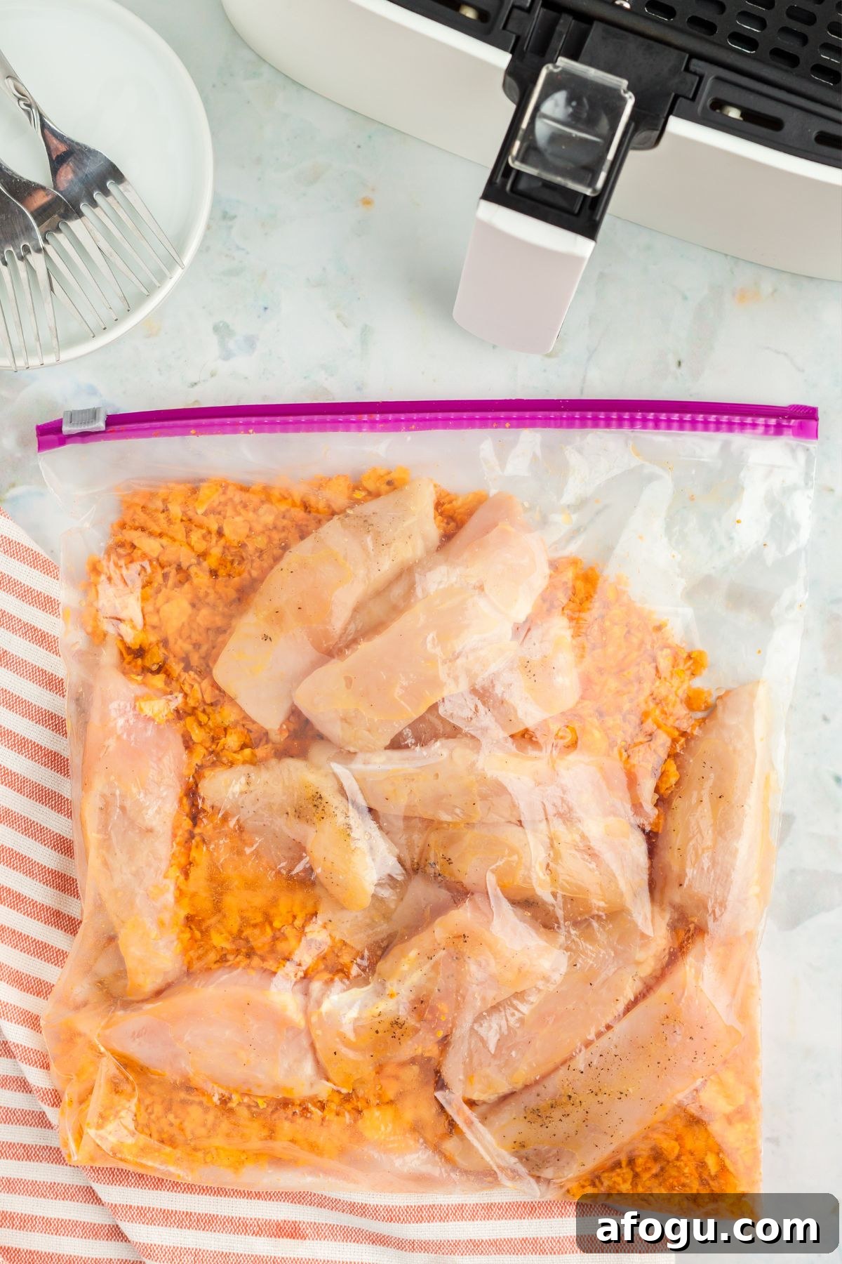 Crispy Dorito-Crusted Air Fryer Chicken Recipe 5 Chicken in a Ziploc bag with crushed dorito chips
