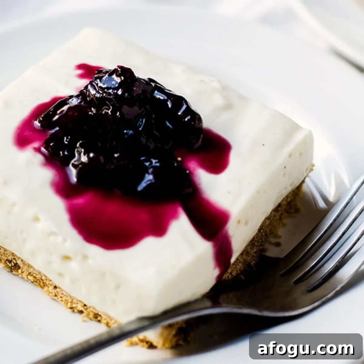 no bake cheesecake bar on a plate with a fork