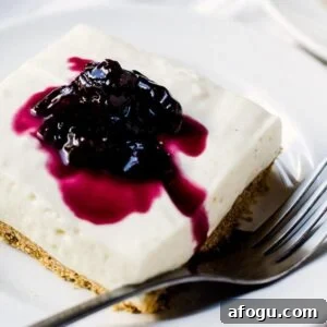no bake cheesecake bar on a plate with a fork