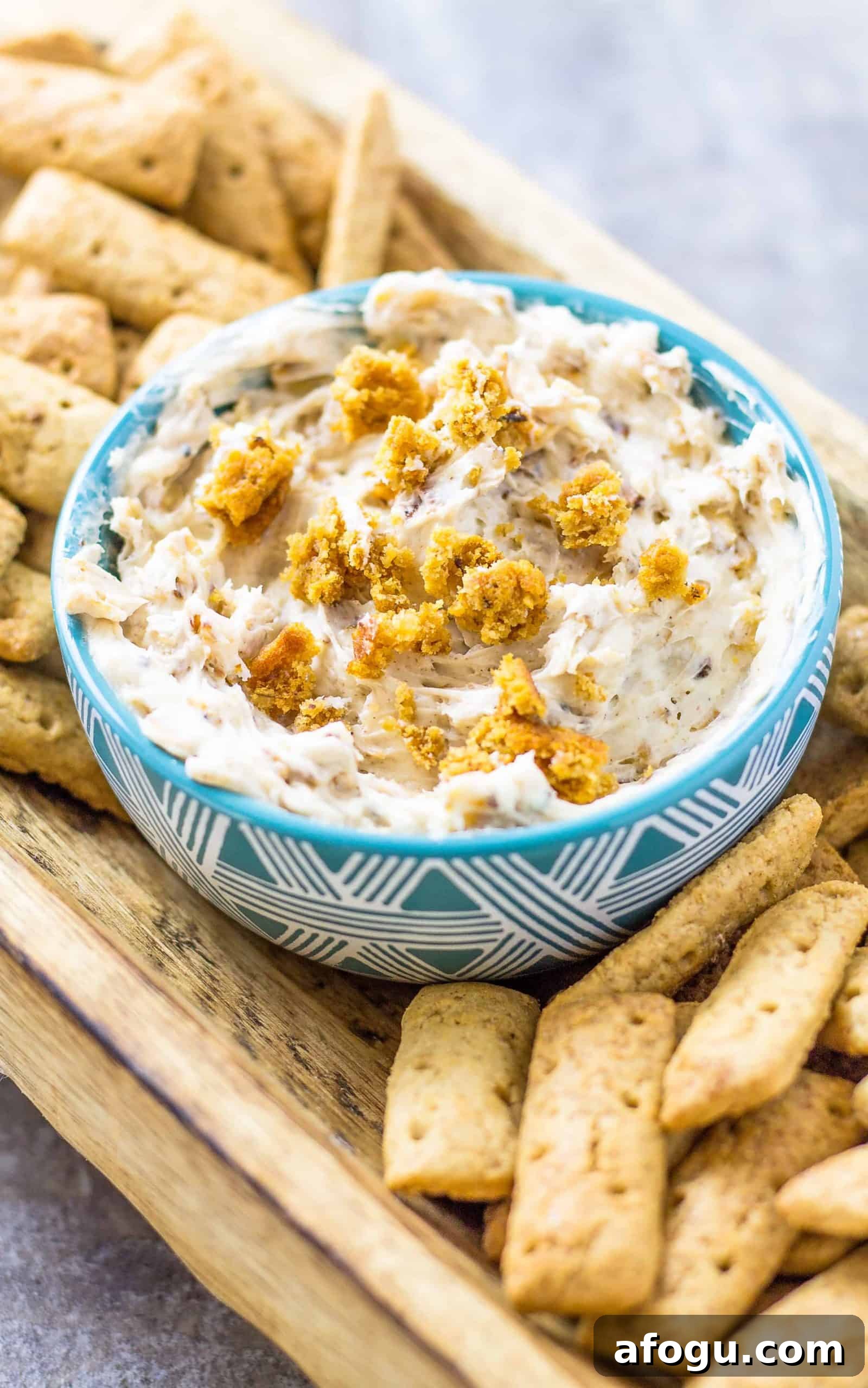 Oatmeal Cream Pie Dip with Cinnamon Sticks on a wood platter