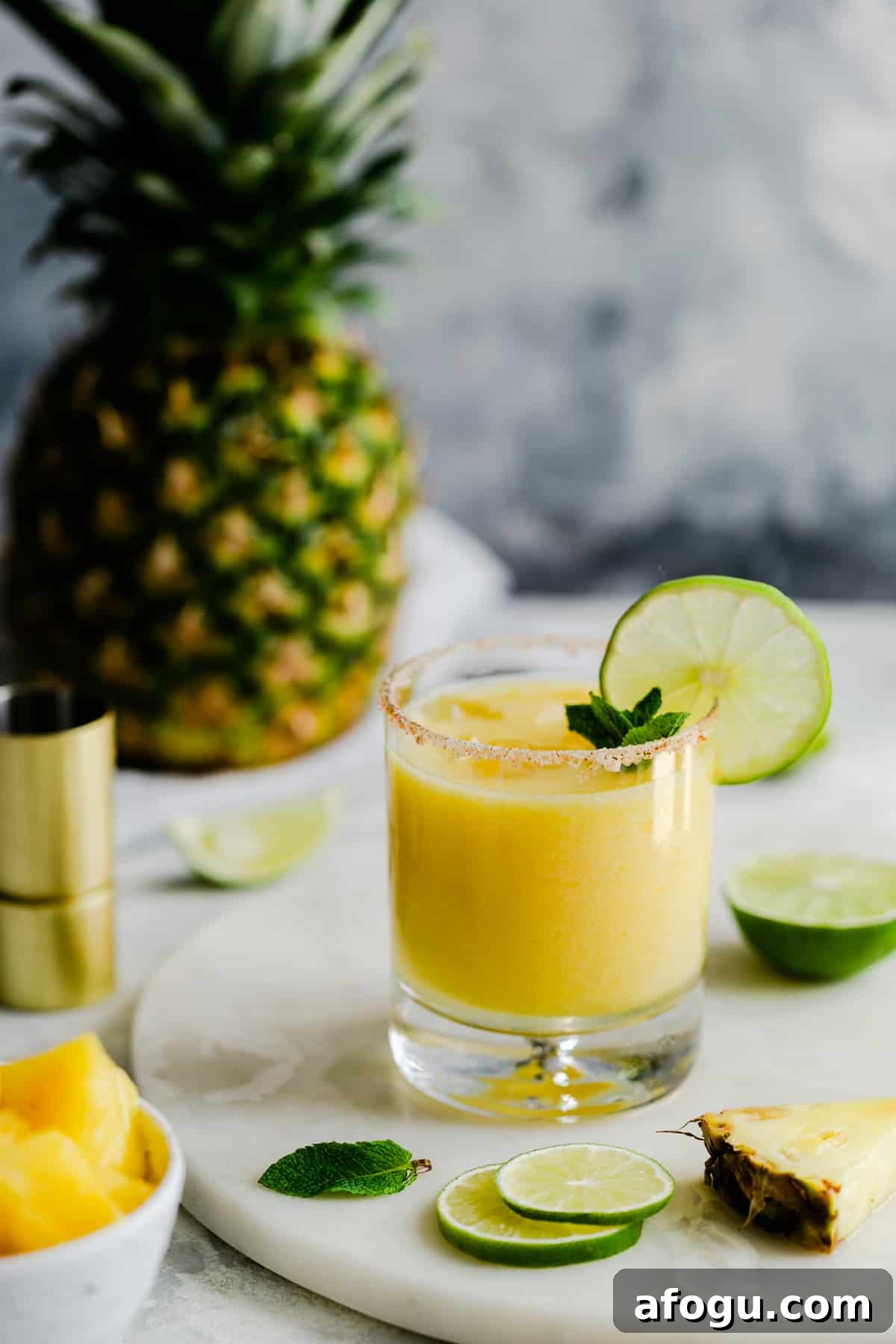 single glass with frozen cocktail and slice of lime