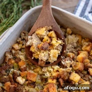 a shot of sausage stuffing with a spoon
