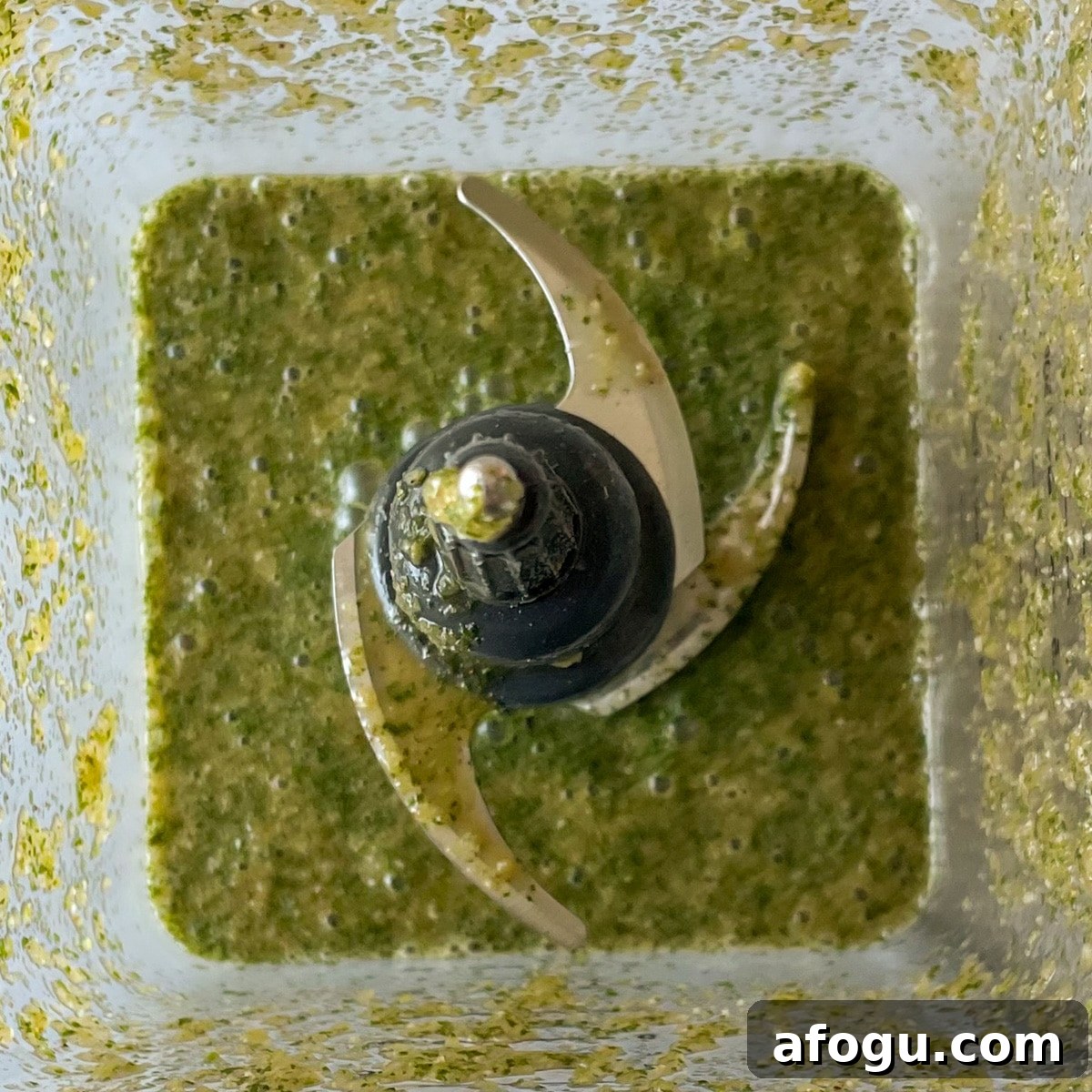 Blended carne asada marinade is shown in the pitcher of a blender.