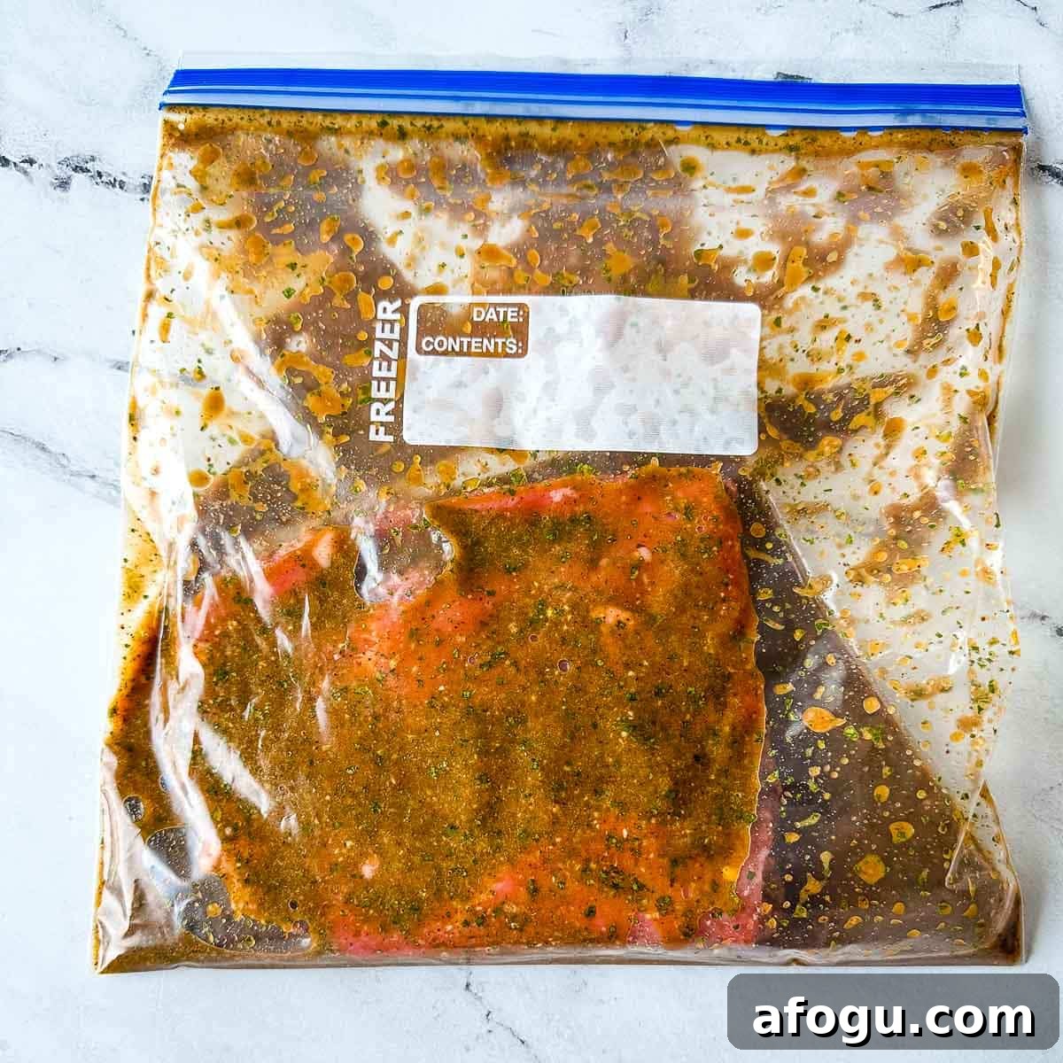Carne asada is shown marinating in a sealed plastic freezer bag.