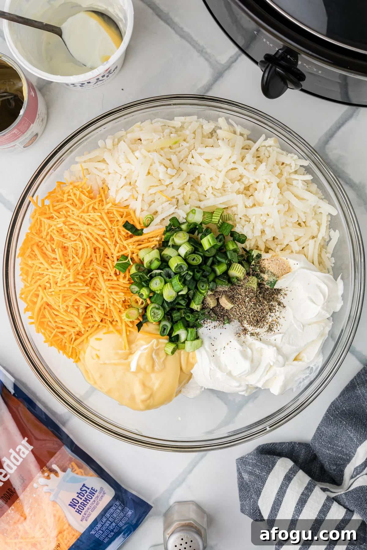 Party potatoes ingredients in a mixing bowl before combining.