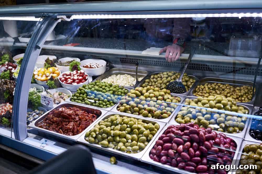 Top Vienna Markets: Where to Shop Local Food, Crafts & Gifts 12 A variety of olives in a deli case at Naschmarkt in Vienna