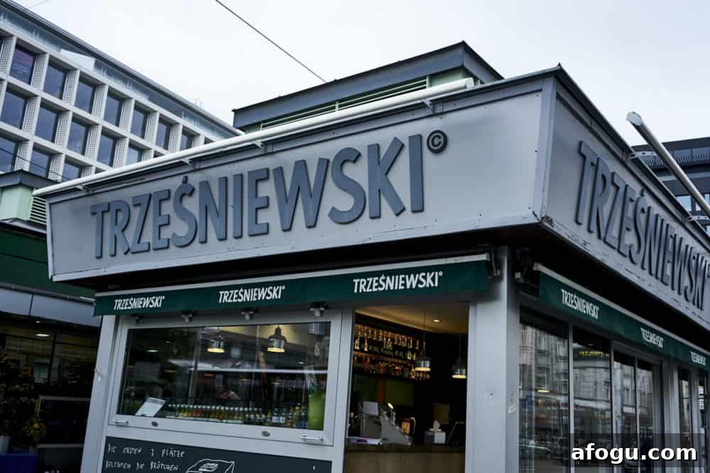 Top Vienna Markets: Where to Shop Local Food, Crafts & Gifts 6 Trzesniewski location at Rochusmarkt Vienna. A small grey building with clear glass walls and green awnings.