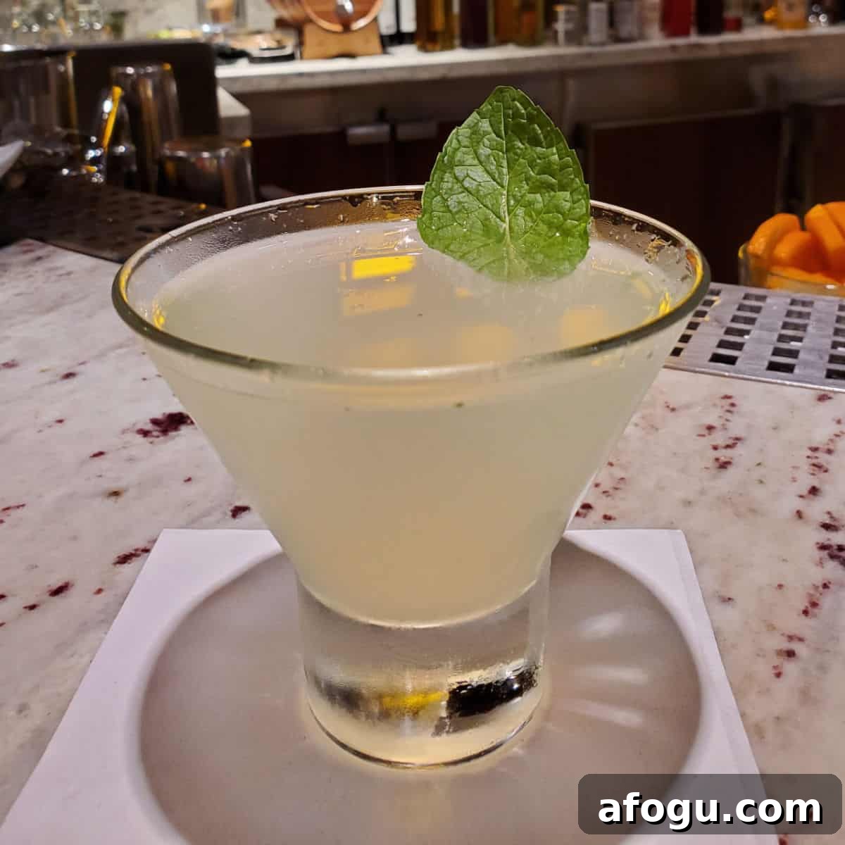 Alchemy Bar Revved Up Mojito Martini on a white napkin with mint leave garnish