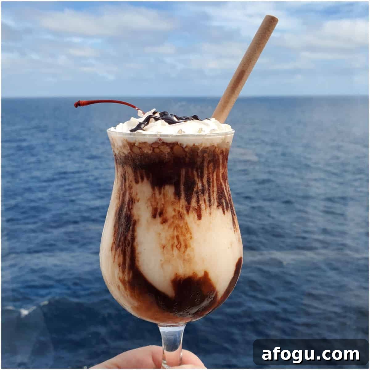 Mocha Chocolate Getaway cocktail being held with a view of the ocean