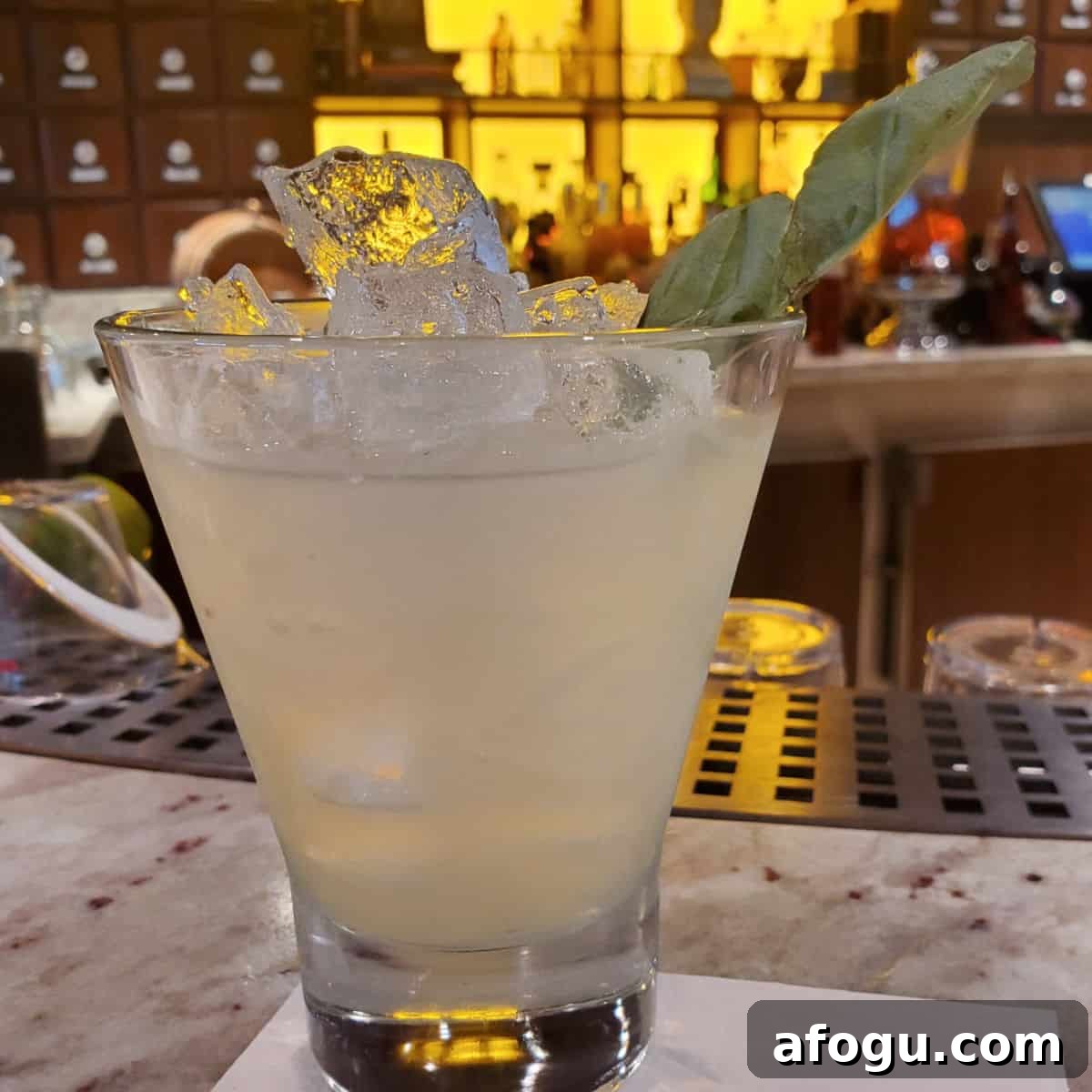 Restorative Basil Drop in a stemless martini glass with a basil garnish