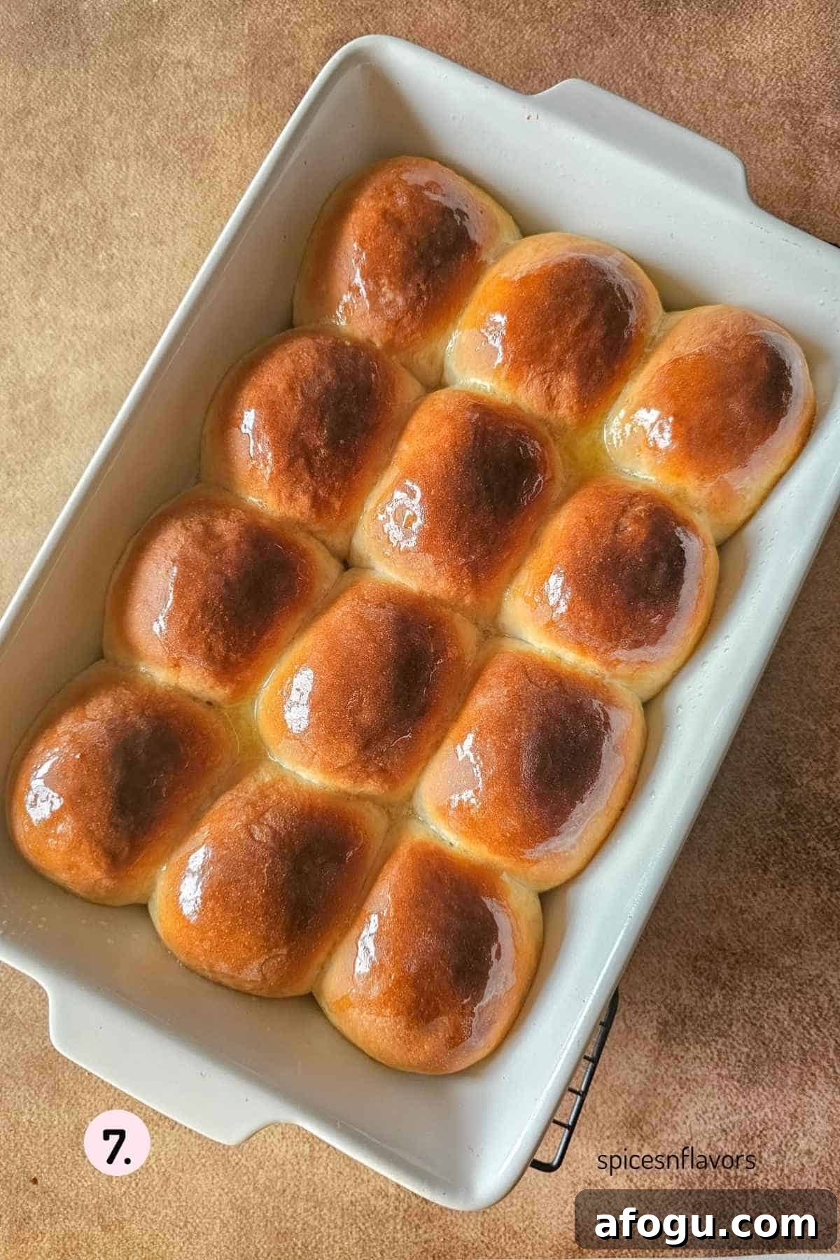 applying butter on baked dinner rolls