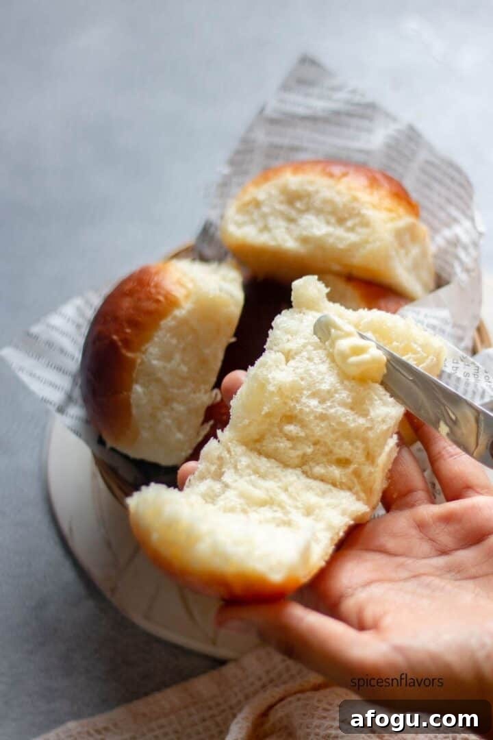 applying butter on dinner rolls