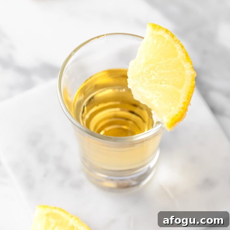 A Wedding Cake Shooter garnished with a slice of sugared lemon.