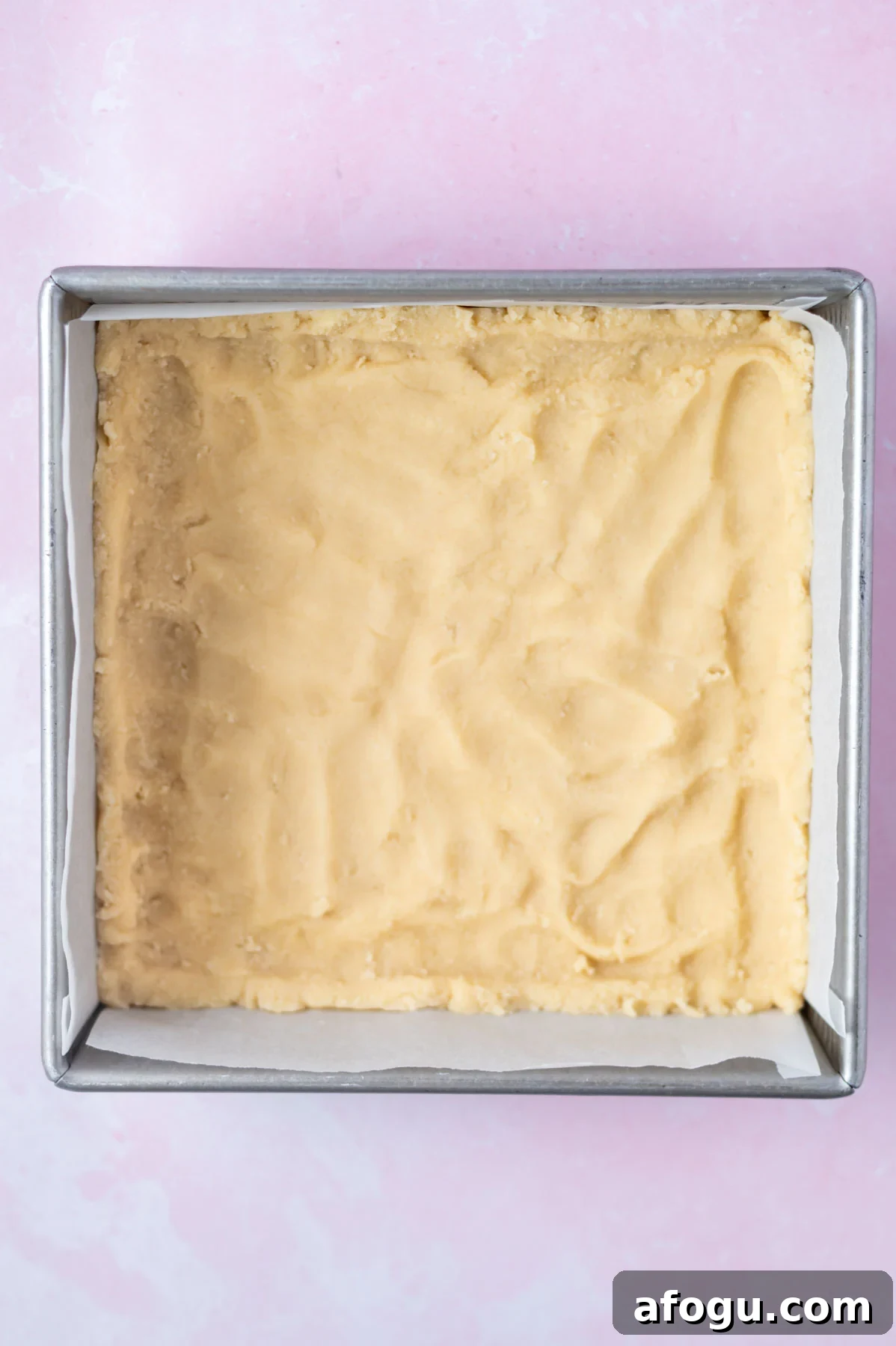shortbread crust pressed into a parchment lined baking pan