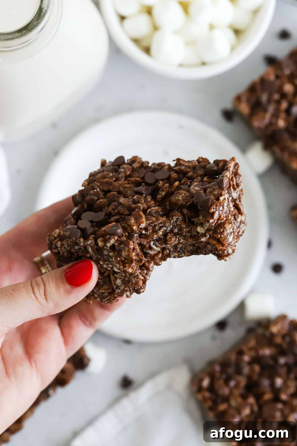 a gluten-free chocolate rice krispie treat with a bite taken out of it