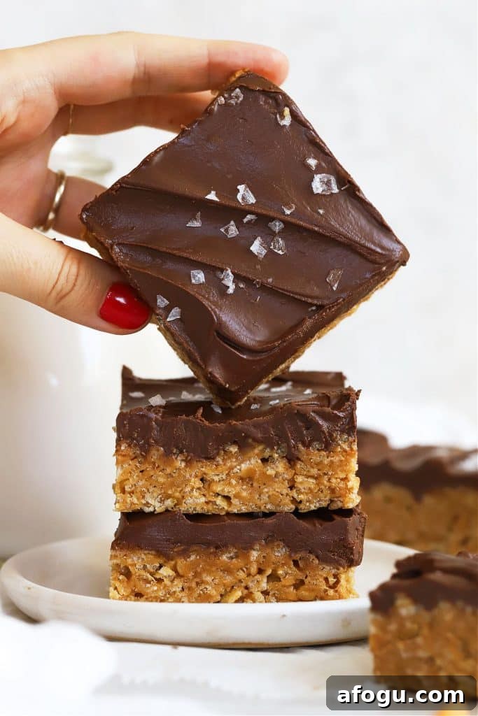 stacking gluten-free scotcheroos on a white dessert plate