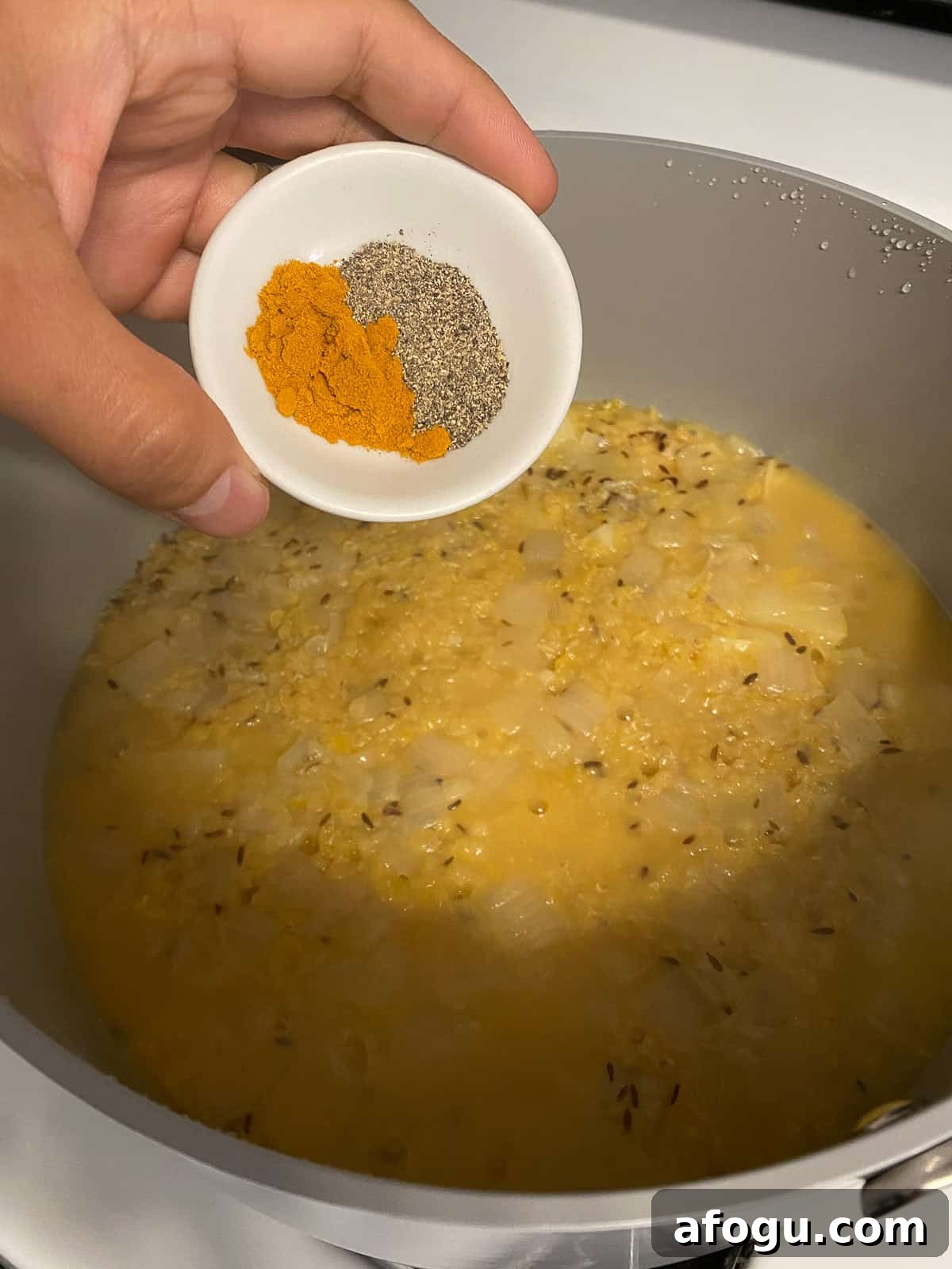 process shot of adding spices to pan