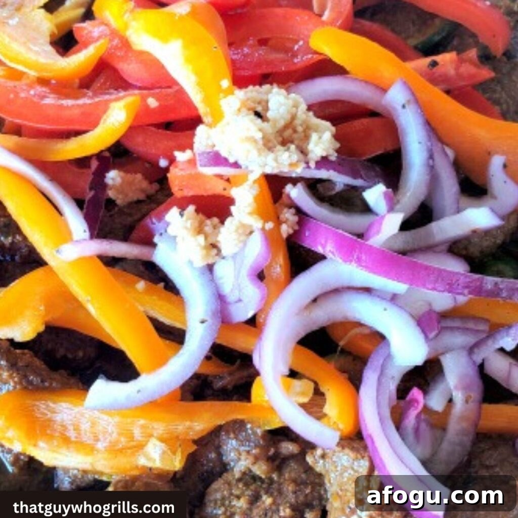 Blackstone Griddle Fajitas: Step-by-Step Griddle Steak & Pepper Recipe 2 Steak fajitas cooking with peppers and red onion on blackstone griddle