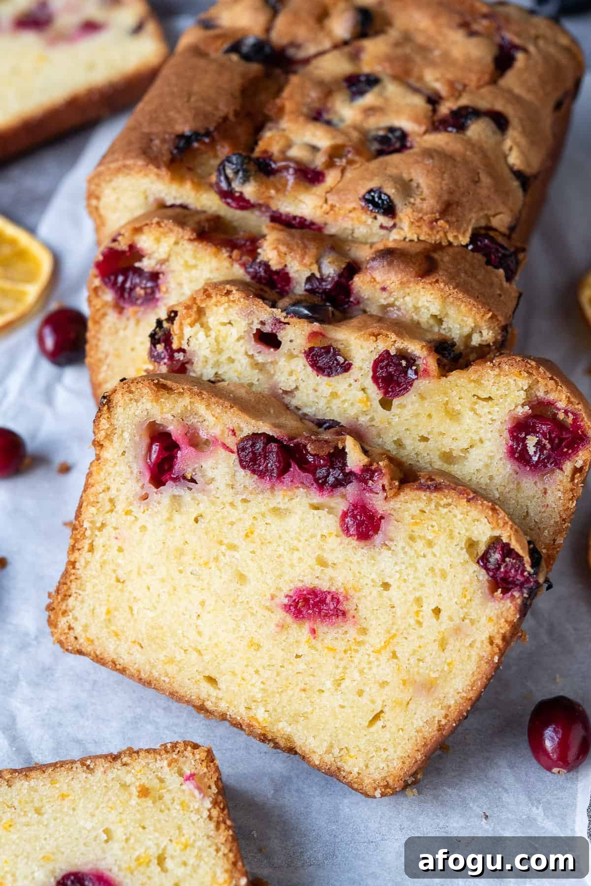 Close up of slices of orange cranberry cake.