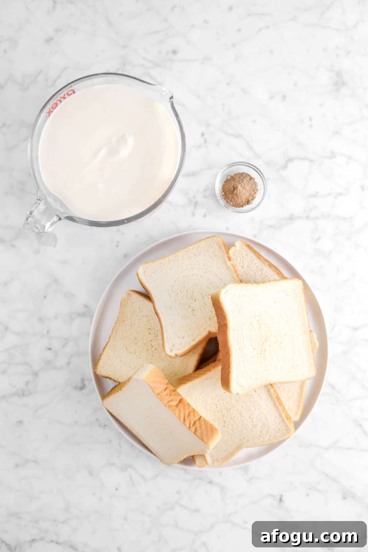 Eggnog French Toast Recipe: Festive Holiday Brunch Idea 4 eggnog, nutmeg, and toast slices on marble counter