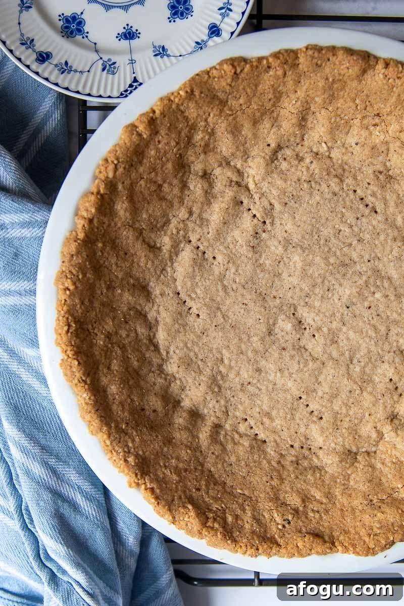 overhead of pie crust made from pecans in a pie plate