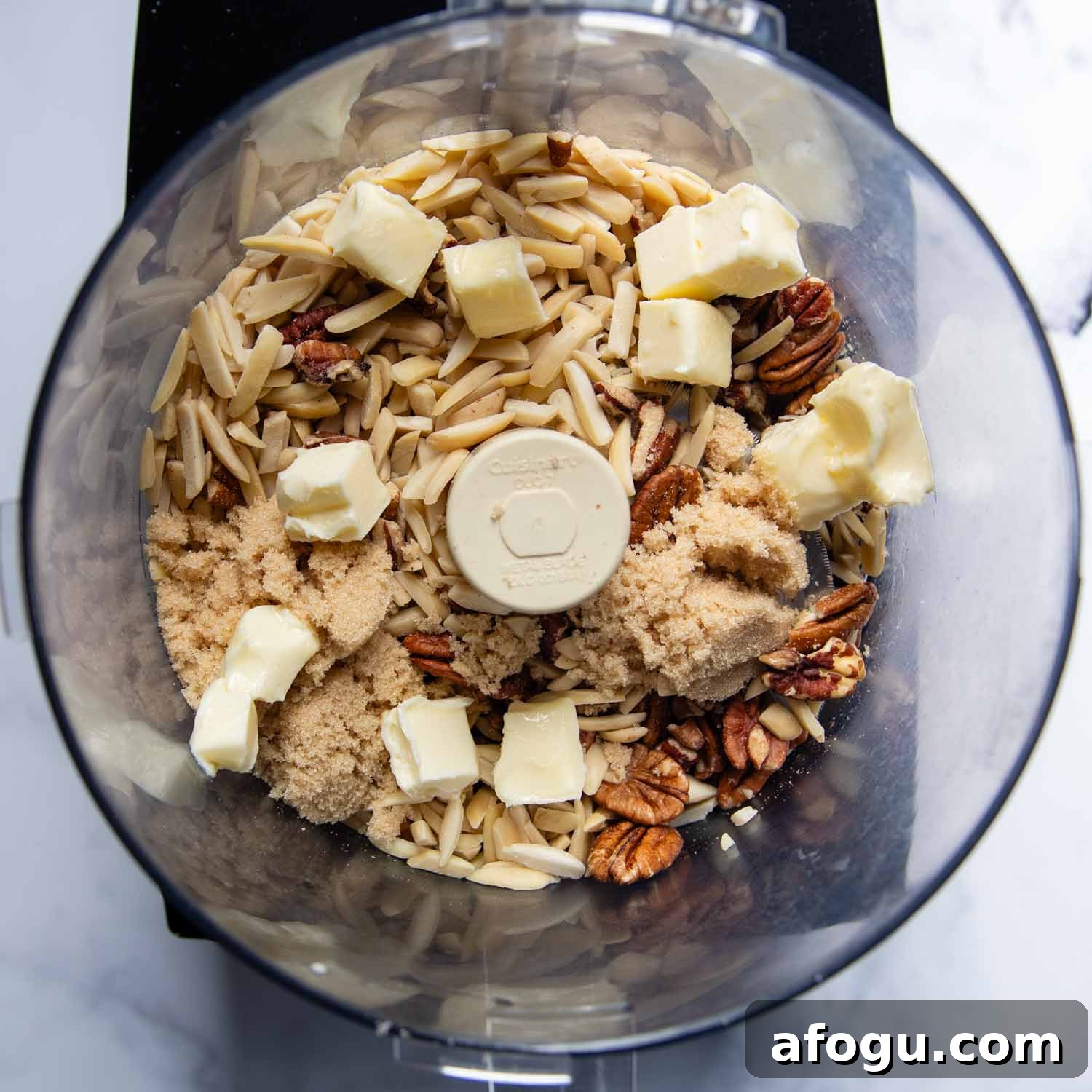 the nuts with softened butter and sugar in a food processor.