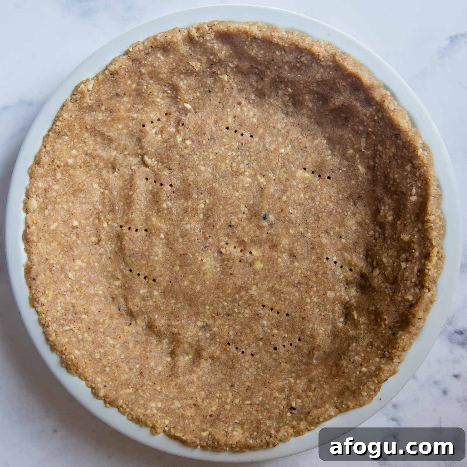 the nut crust pressed into a pie pan, unbaked.