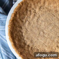 overhead of pie crust made from pecans in a pie plate