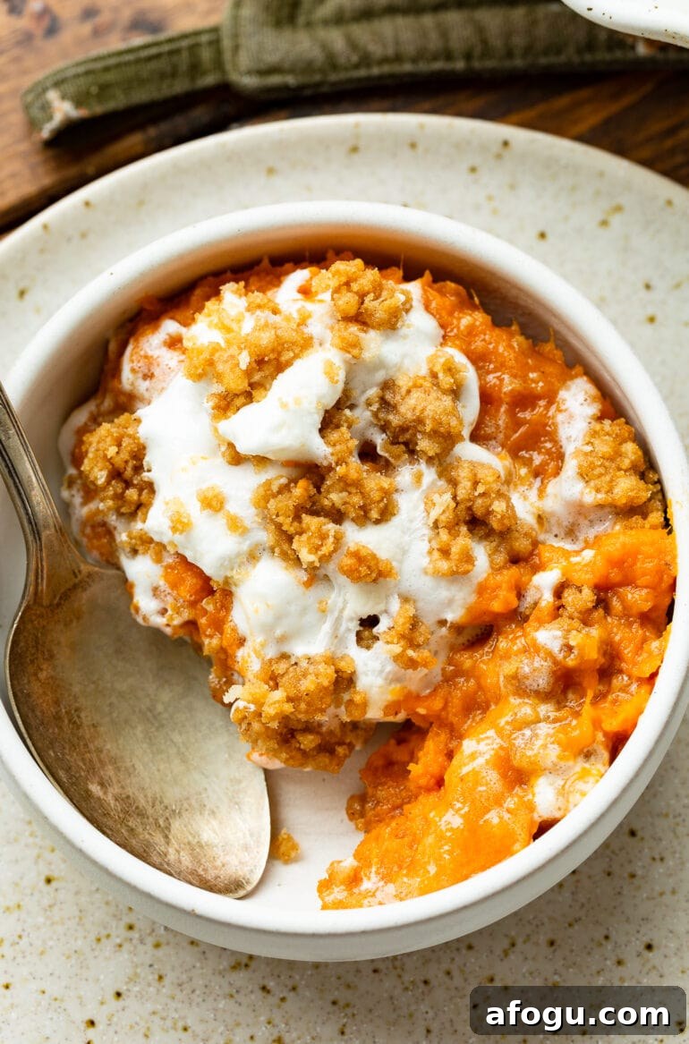 a photo of a serving of sweet potato casserole with marshmallows and brown sugar crumb topping