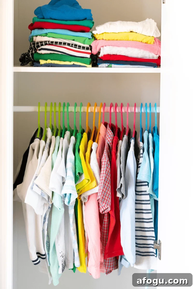 An organized kids closet with clothes stored neatly