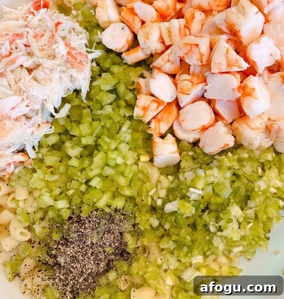 Adding chopped cooked shrimp, salt and pepper to the pasta salad preparations.