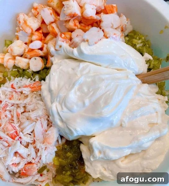 Adding Mayonnaise, sour cream, relish, and sugar to the salad mixture.