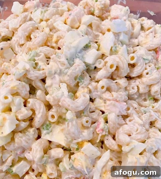 Seafood Macaroni Salad mixed in a bowl and ready to chill in the refrigerator.