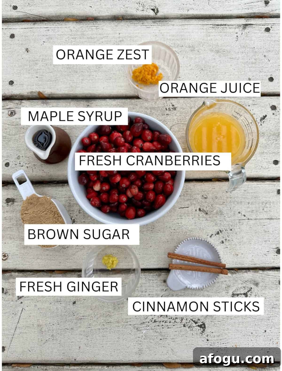 Ingredients for Orange Cranberry Sauce in small containers on a table.