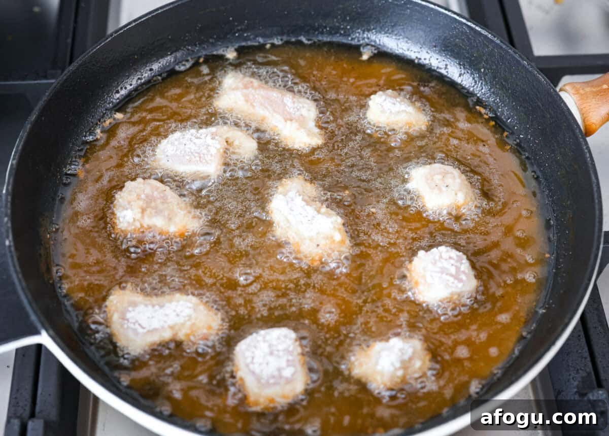 Chick fil a nuggets being cooked in oil. 