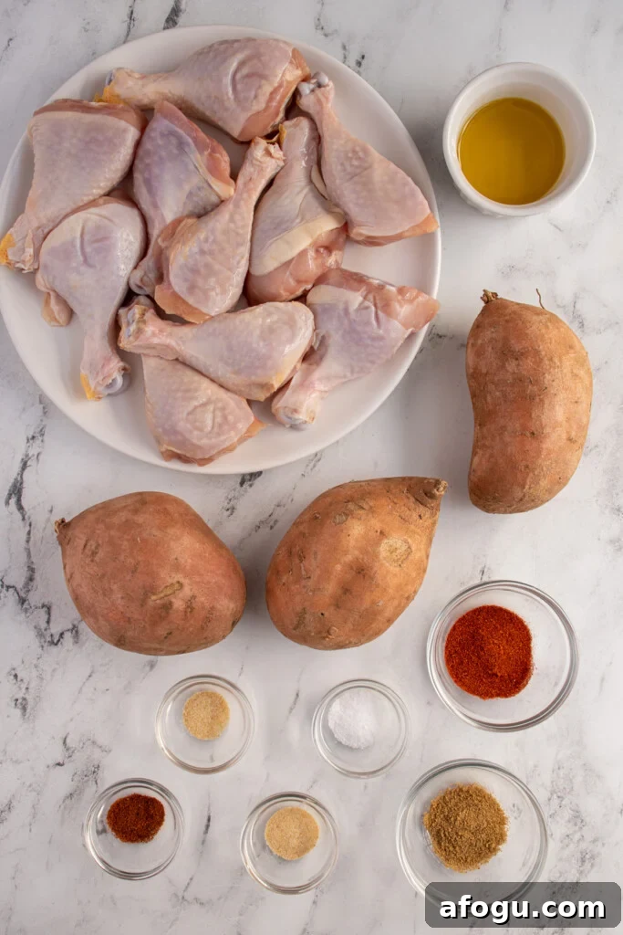 Ingredients needed to make sheet pan chicken legs and sweet potatoes laid out on a tabletop.