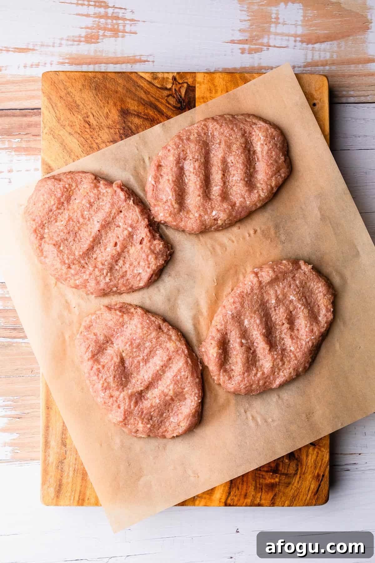 Four ground turkey patties to make salisbury steaks.