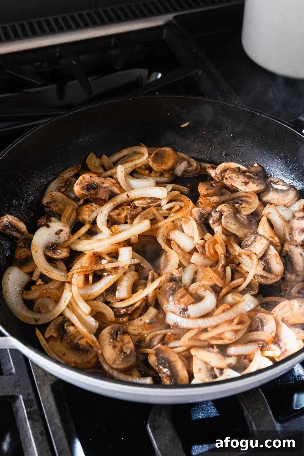 Cooked mushrooms and onions in the skillet.