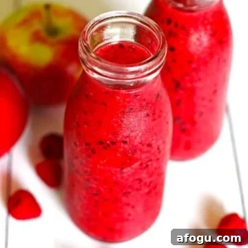 Two jars of a healthy apple berry smoothie.
