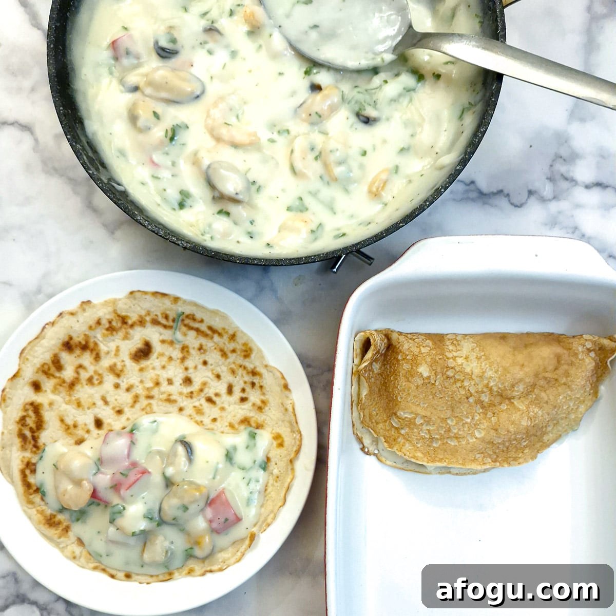 Pancakes being filled with seafood sauce and placed in a baking dish.