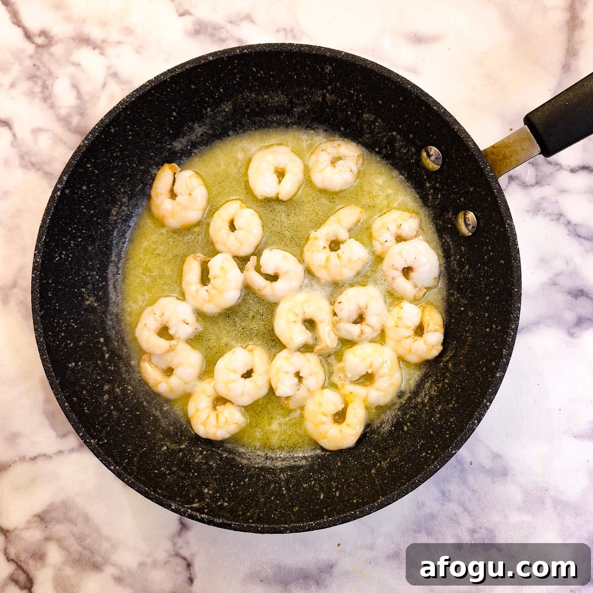 Prawns being sauteed in butter.