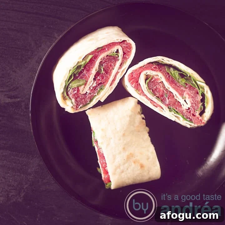 A square photo of a black background with a black plate with three tortilla snacks filled with carpaccio, arugula, parmesan cheese.