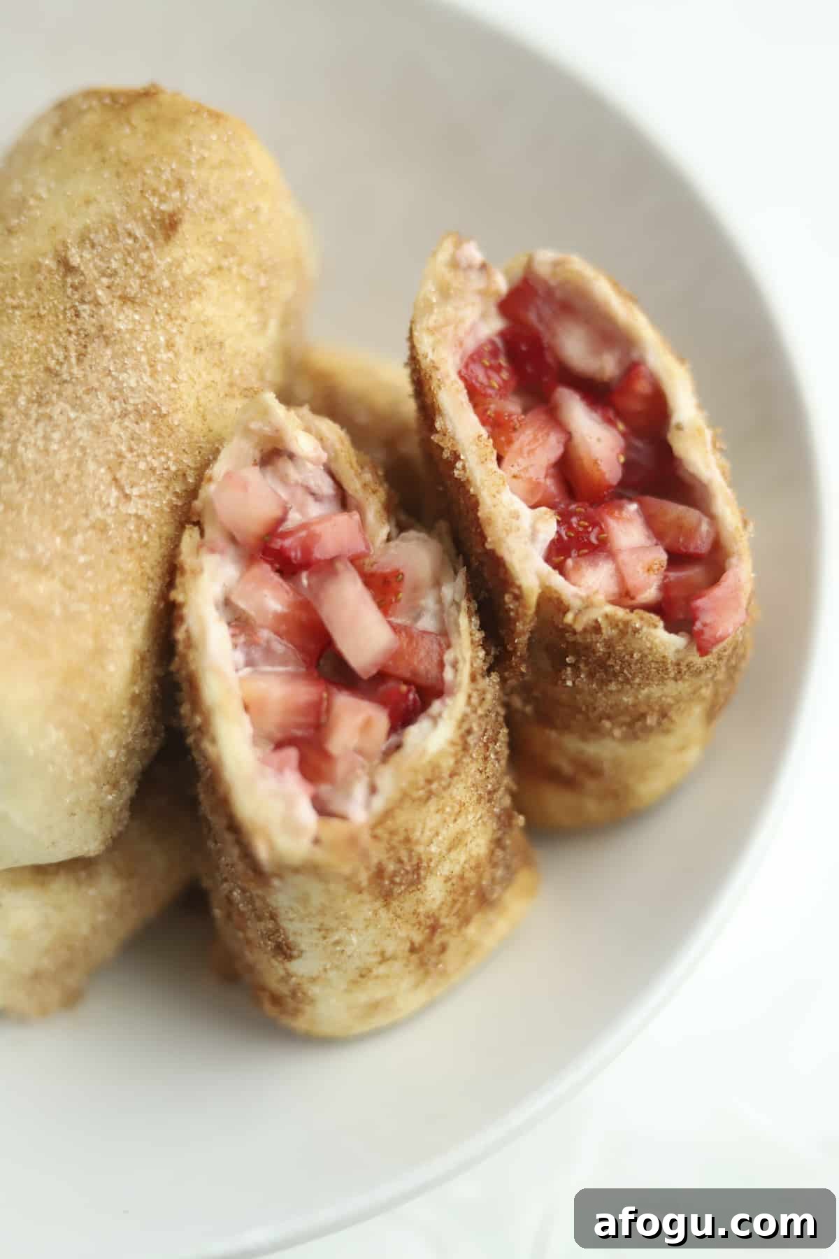 opened stuffed chimichanga with fresh strawberries